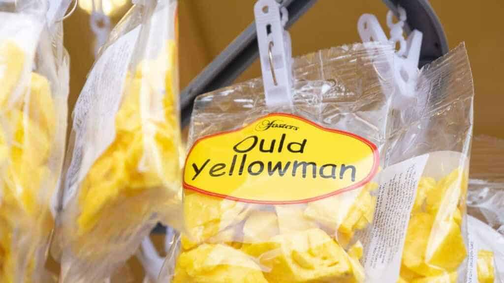bag of delicious Yellowman, traditional sweets, honeycomb style confection, on market stall at the Ould Lammas Fair.