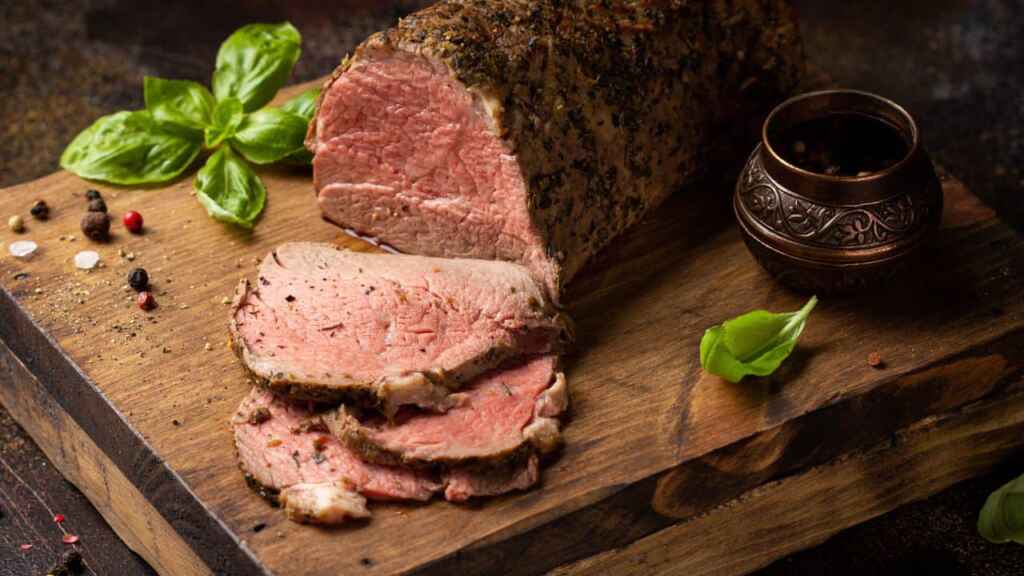 Juicy roast beef with spices sliced on a cutting Board