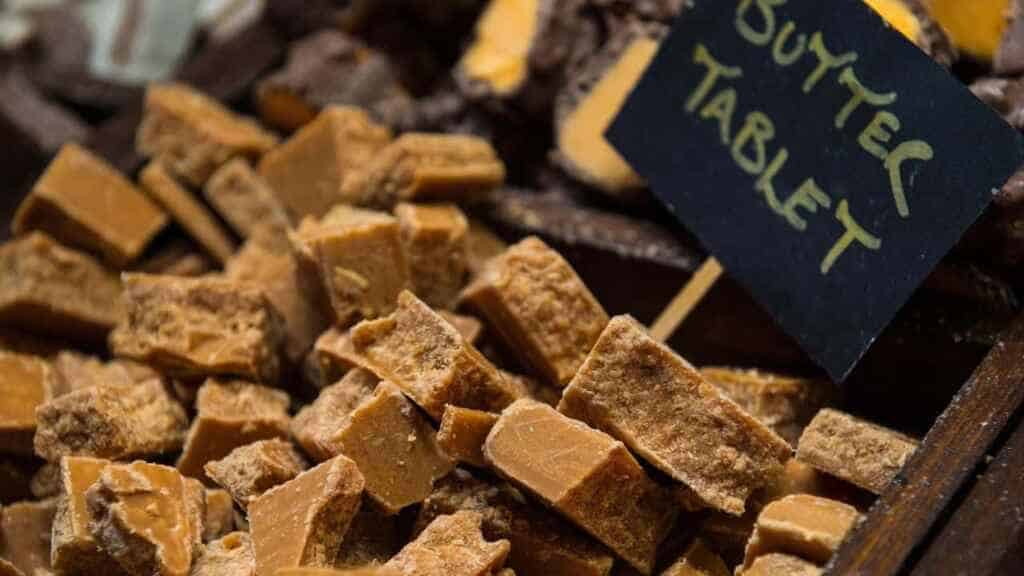 Scottish Fudge or Tablet on display in a shop with a little sign saying the flavor is butter tablet