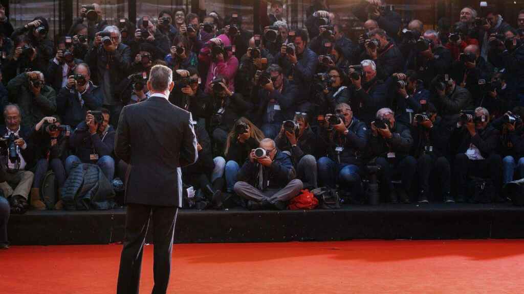Tom Hanks and photographers at a film premiere