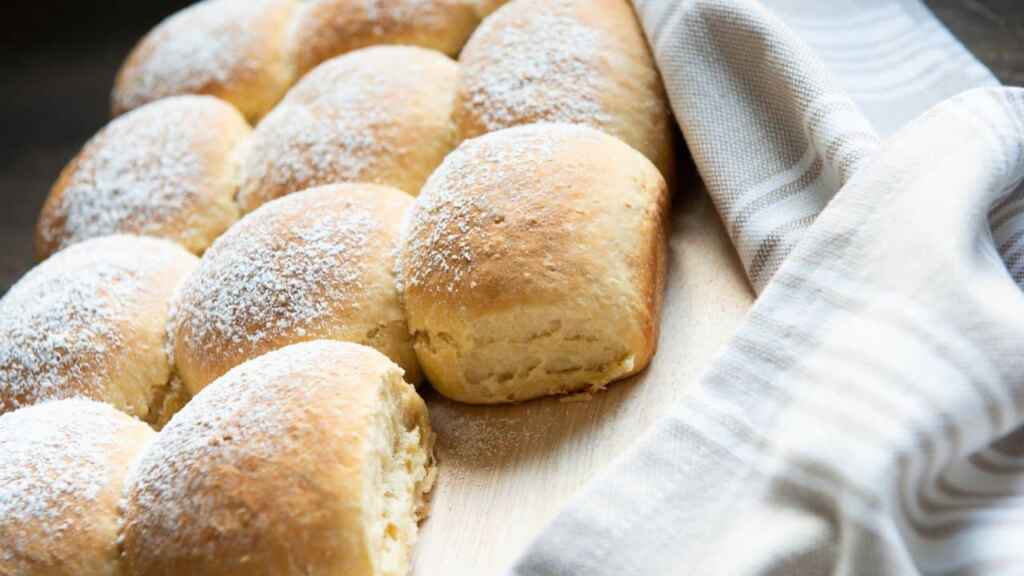 Fluffy homemade austrian powdered buchteln backed and decorated on wooden board