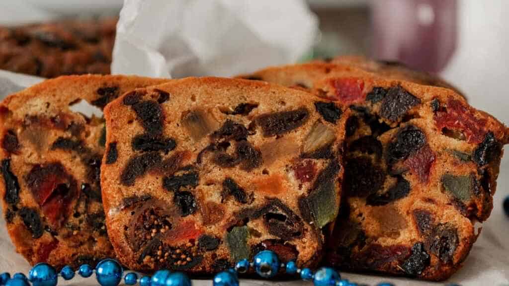 English dried fruitcake. Traditional Christmas cake with almonds, dried fruits, dates, candied Fruits.Fruitcake. concept New year, Christmas spirit and decorations