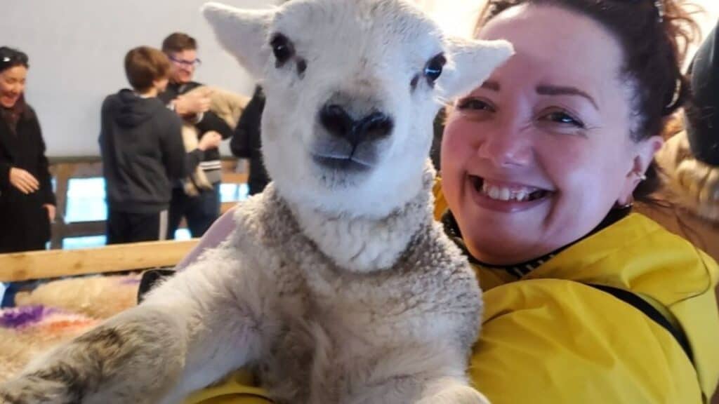 Jessy holding a lamb in Ireland