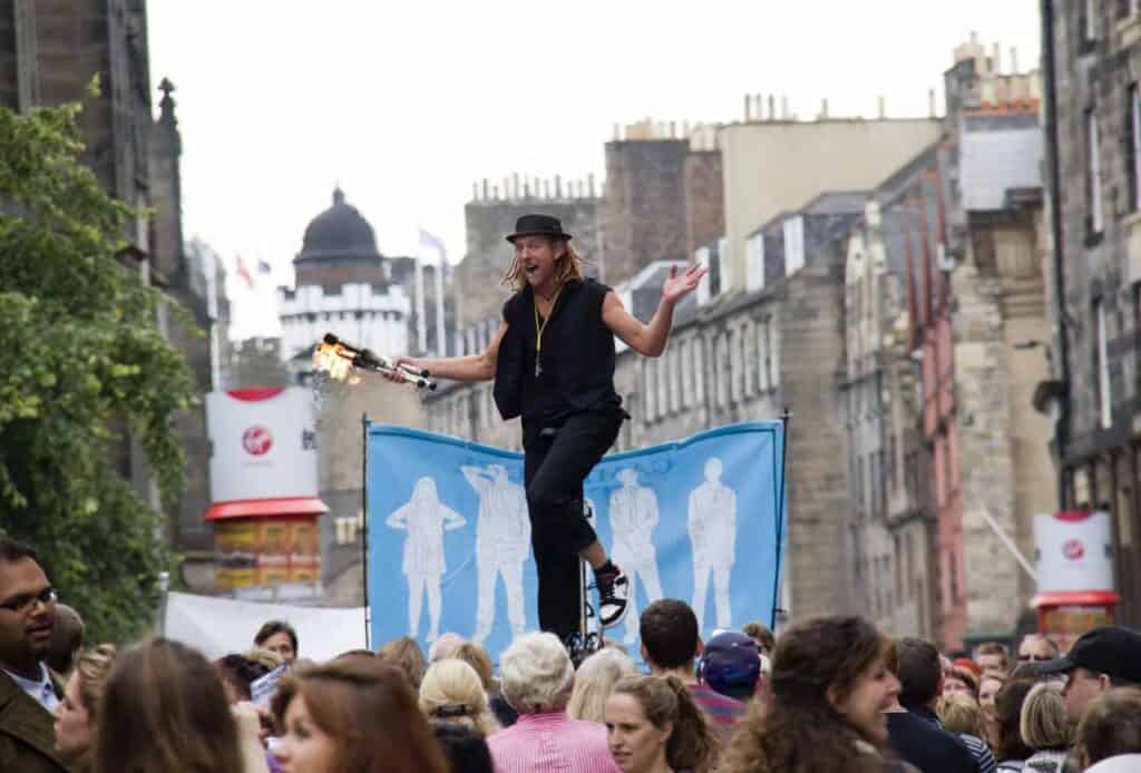 EDINBURGH, UK: AUGUST 2: Unidentified man juggles torches on a unicycle at the Edinburgh Festival Fringe in Edinburgh, UK on August 2, 2012