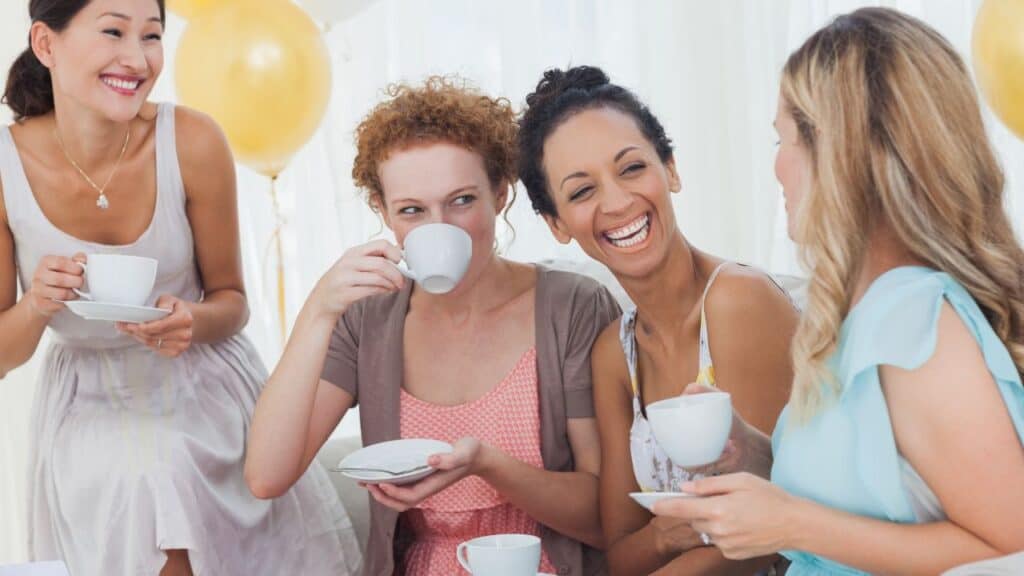 Friends drinking tea and chatting at a party