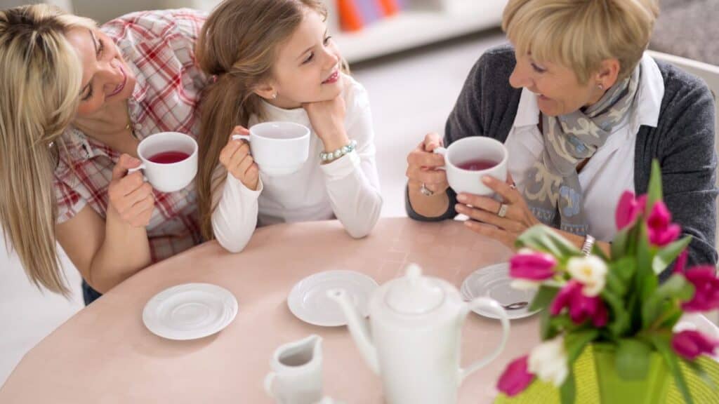 Mother, grandmother and daughter together on tea party