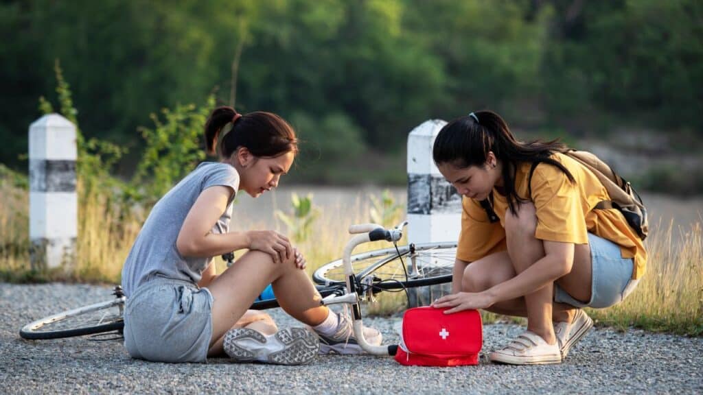 First aid kit being used out on a bicycle trail.