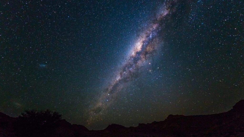 Milky Way arch, stars in the sky, the Namib desert in Namibia, Africa. The Small Magellanic Cloud on the left hand side