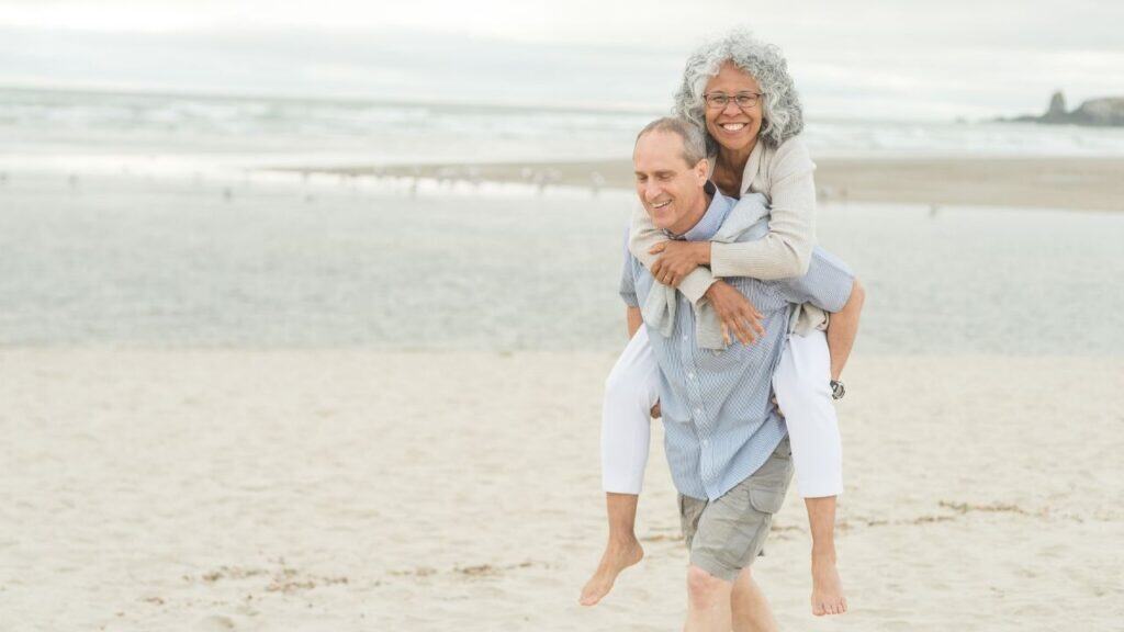 Cute Older Couple Walk on the Beach
