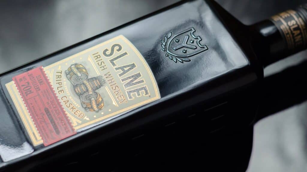 Characteristic black bottle Slane Irish whiskey, blend of grain and malt whiskeys matured in the distinctive flavours of three casks