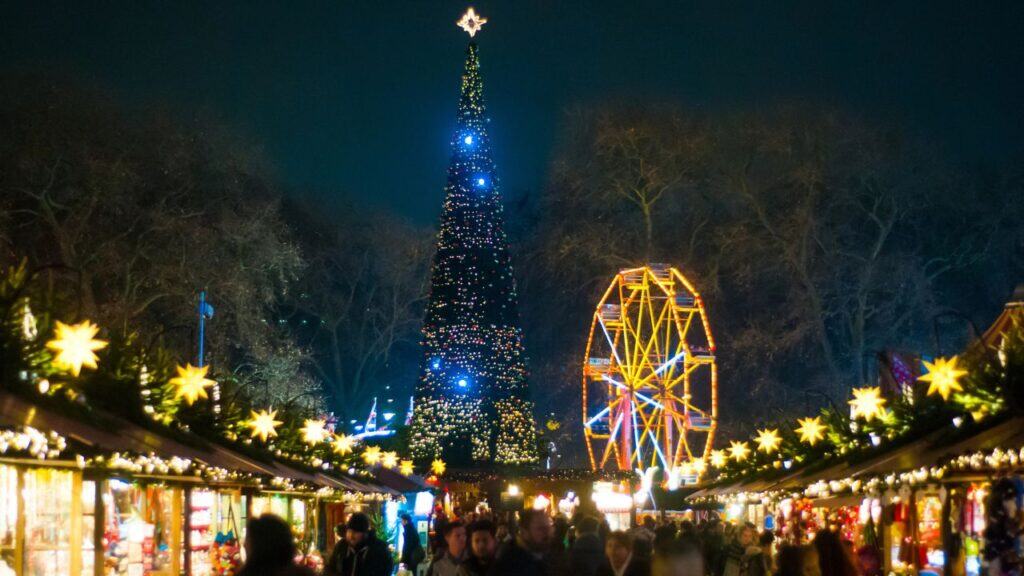 LONDON, UK - DECEMBER 2016: People at Winter Wonderland in Hyde park enjoy food, drink and christmas market at night during Christmas and New years celebrations in London, United Kingdom.